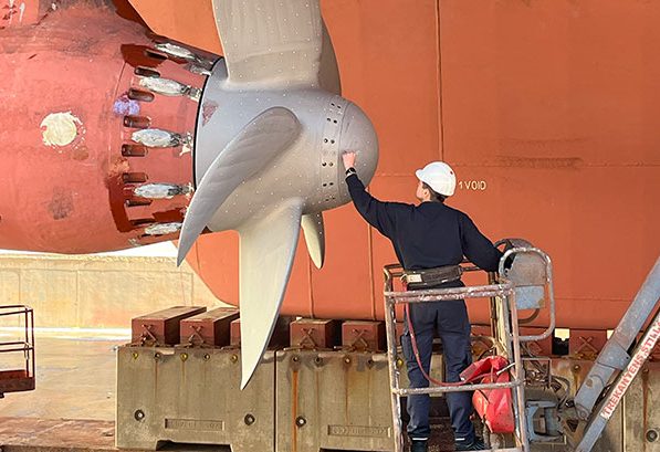 A man inspecting a large ship rotor